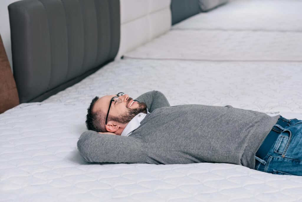 Man testing memory foam hybrid mattress