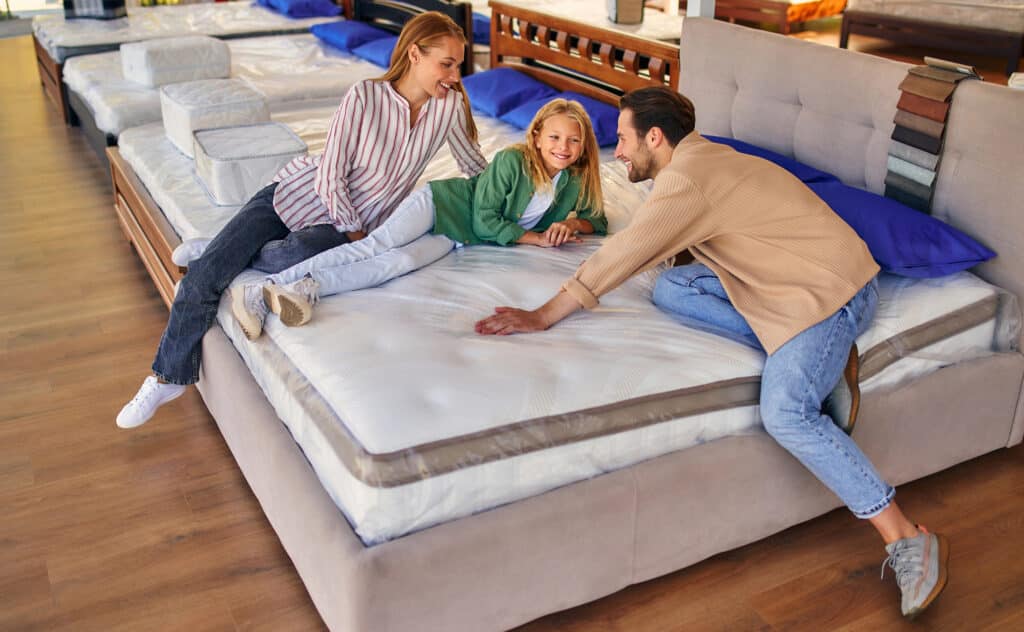 Fort Worth customers trying memory foam mattresses at Haltom Mattress Factory